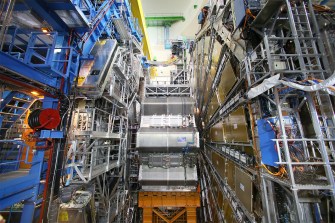 Interior view of the ATLAS detector at CERN’s Large Hadron Collider, showing intricate machinery and scaffolding inside the underground facility.